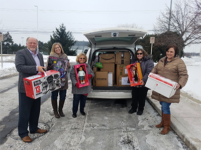 Genisys Team packing Van with gifts